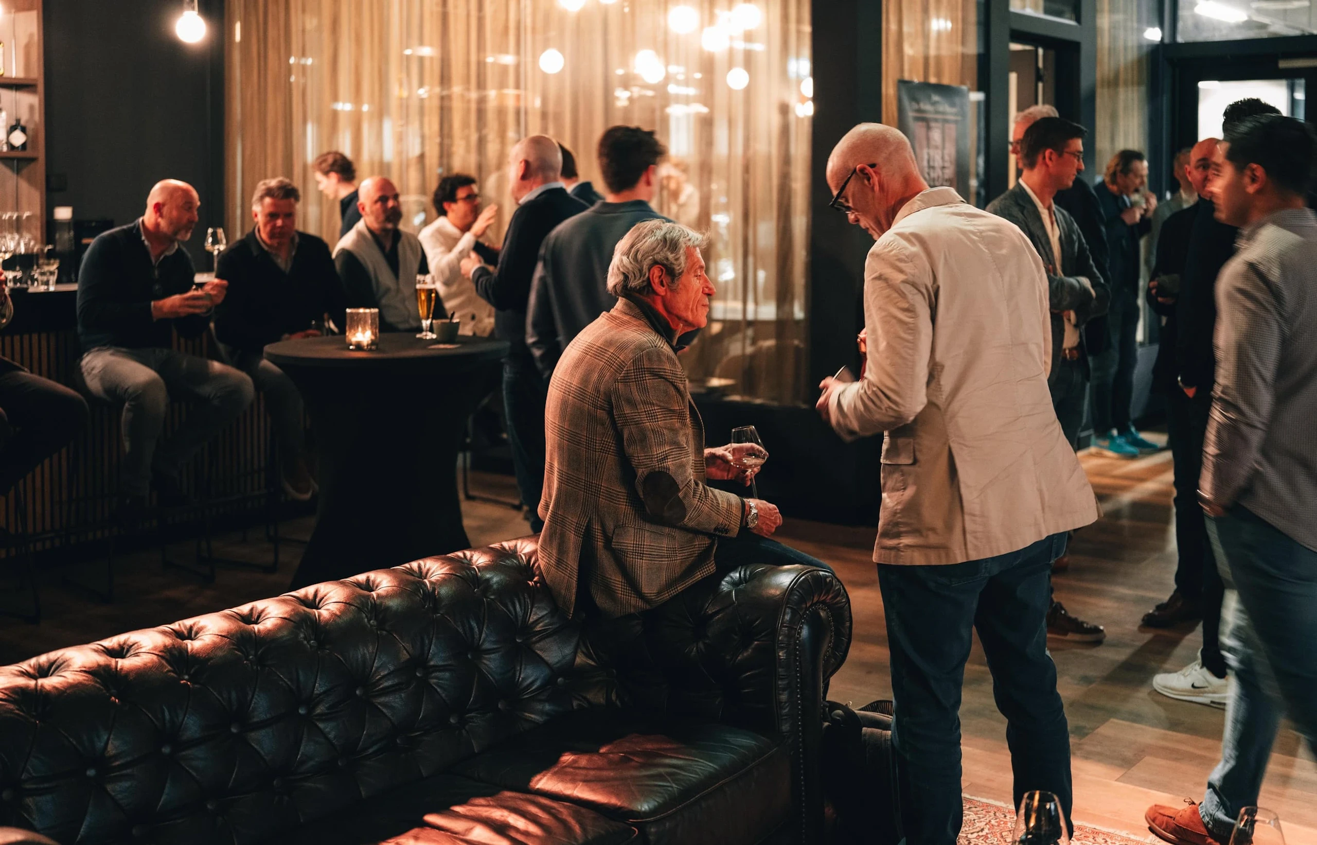 Guests talking over drinks at the Lecarage evening