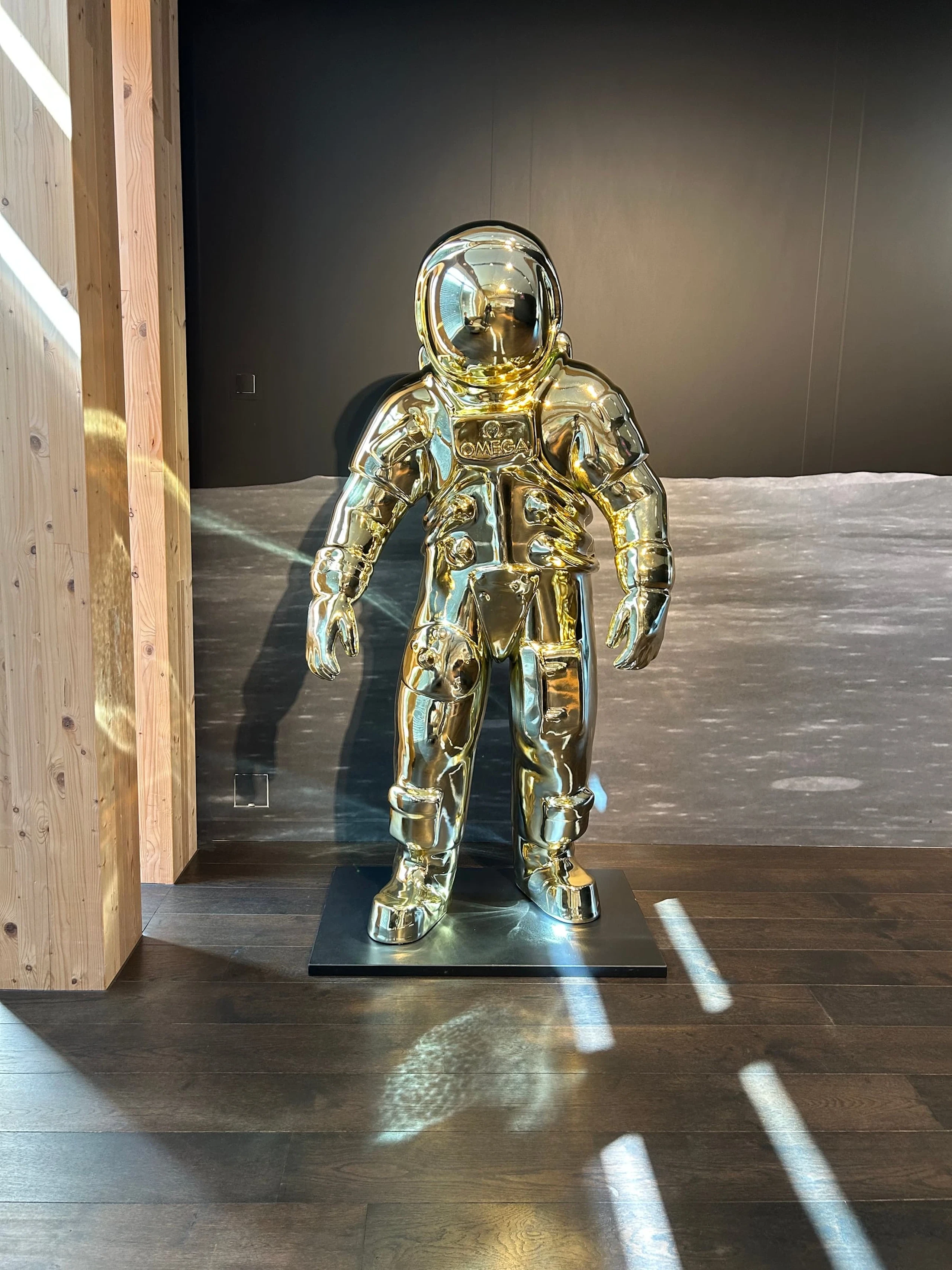 A gold astronaut figure on display at the Omega Museum