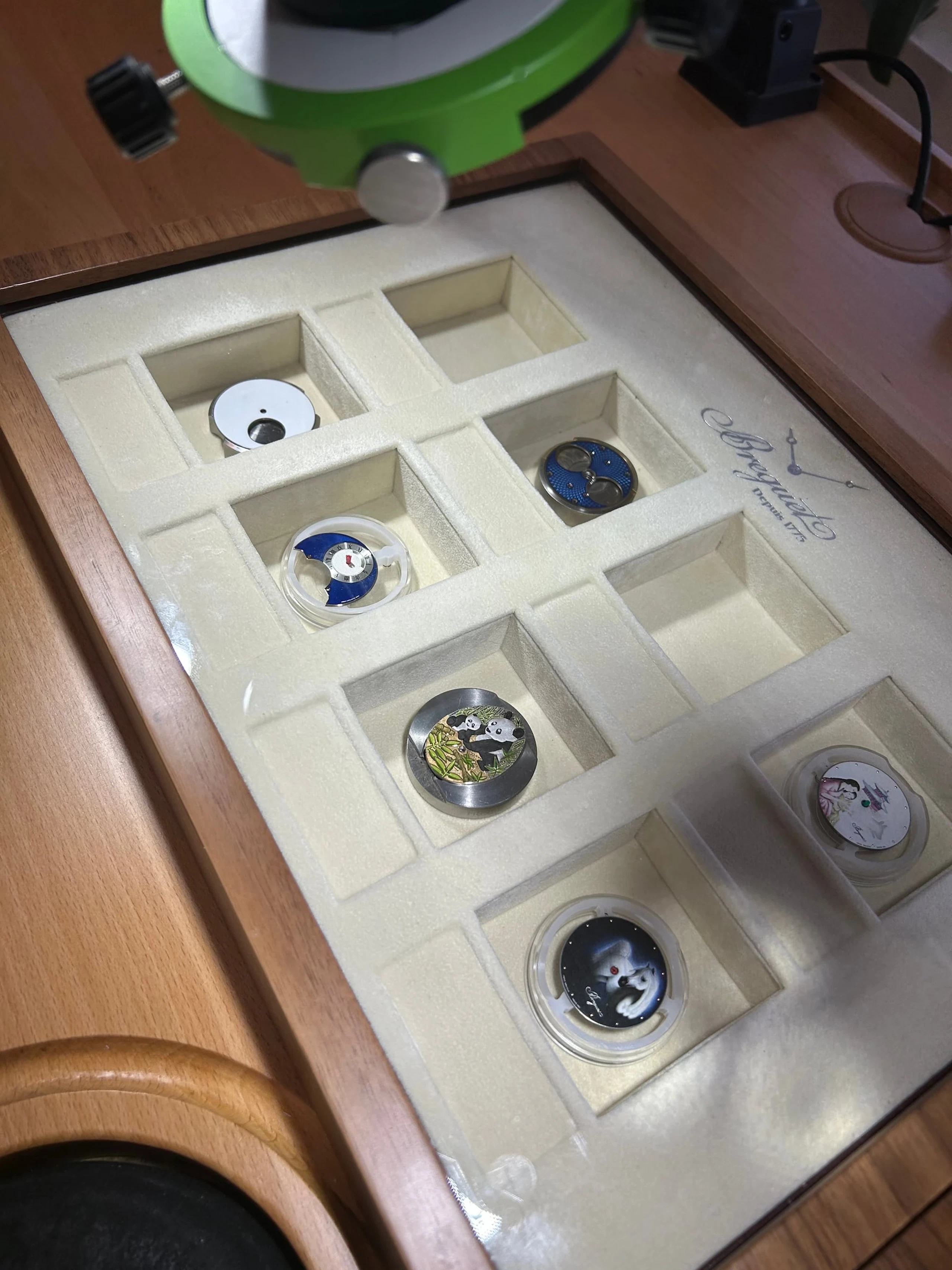 Watch movements laid out in a display case at Breguet