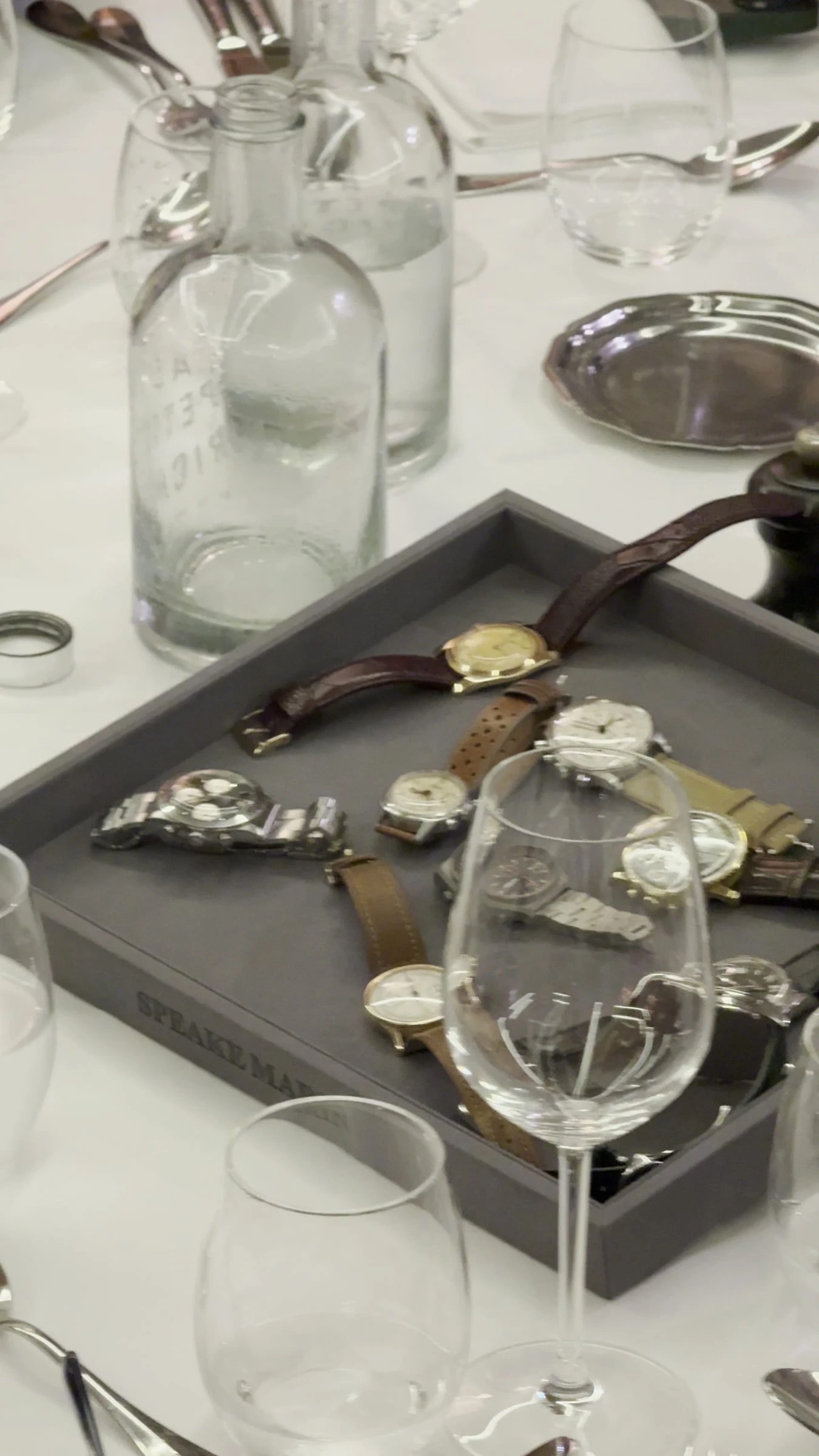A tray of watches passed around at a member dinner
