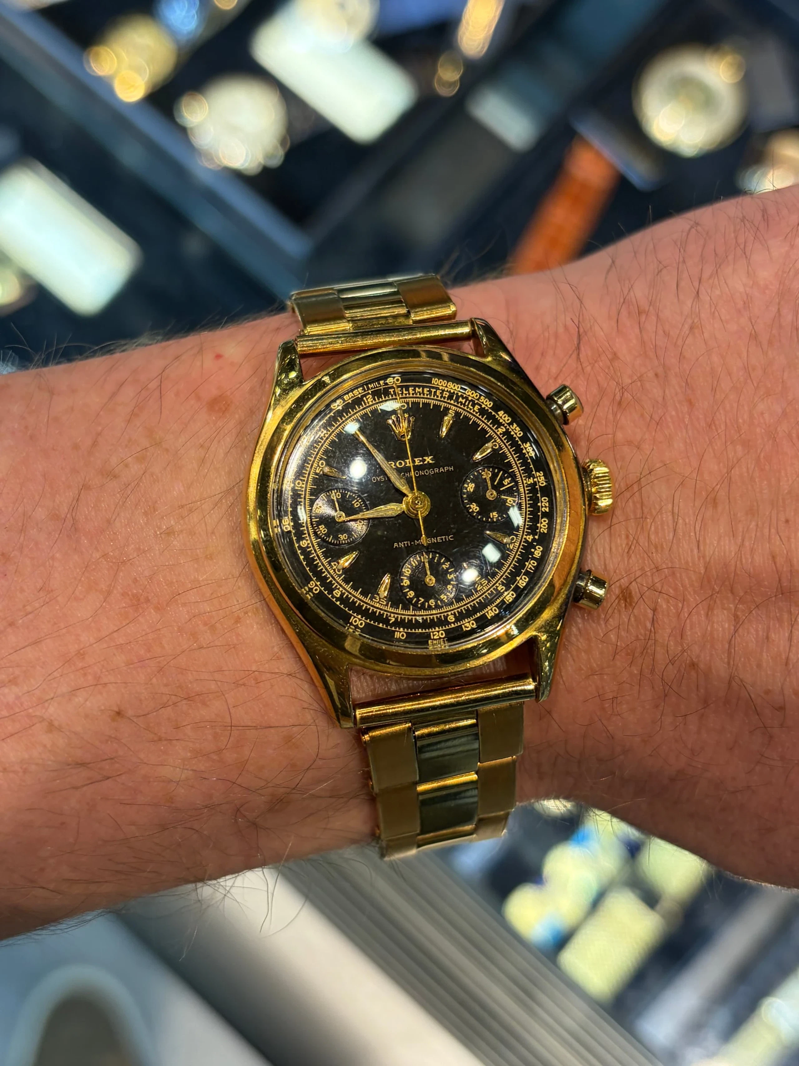 A gold chronograph on a dealer’s wrist in Miami