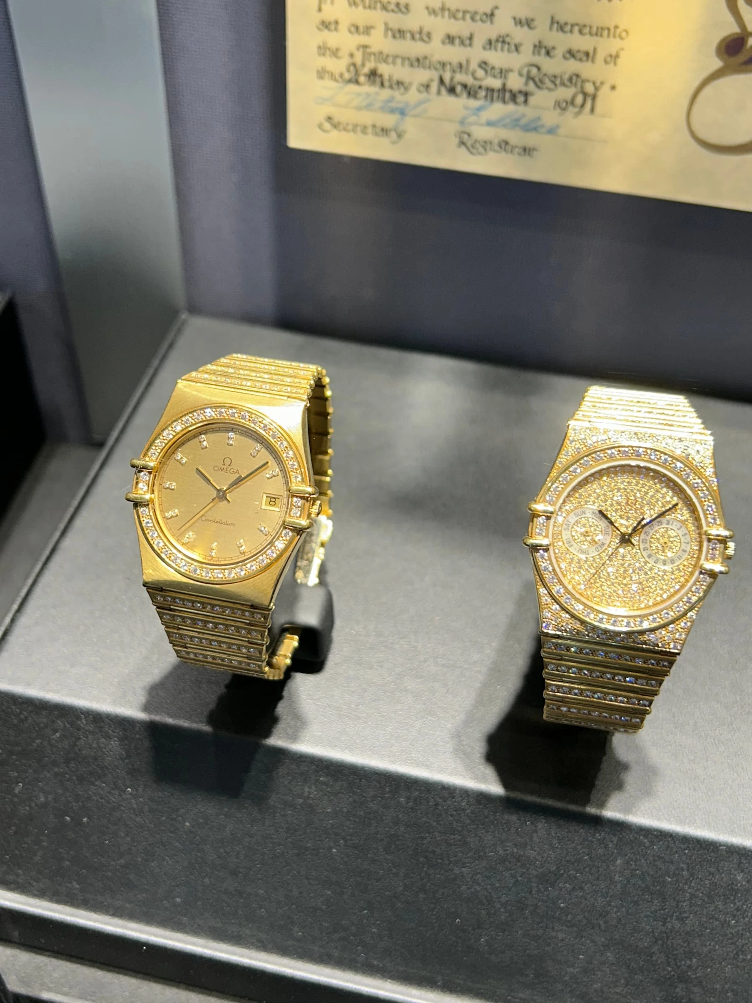 Gold Omega watches in a museum display case